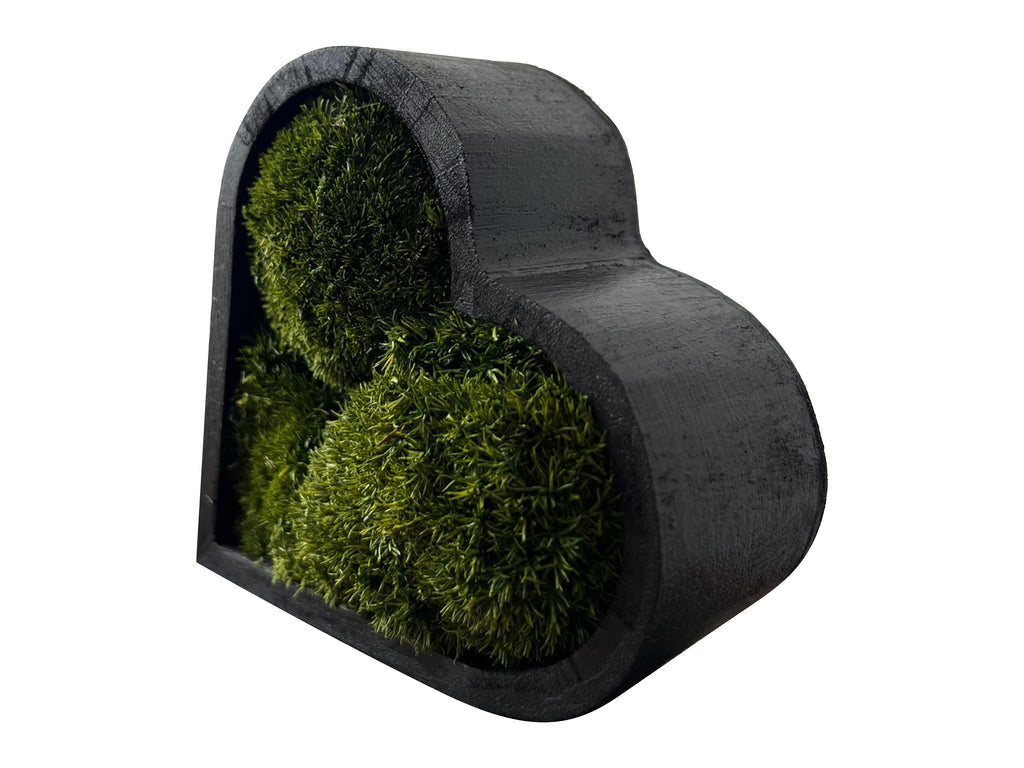 Detail view of heart moss art showing wooden frame and moss structure